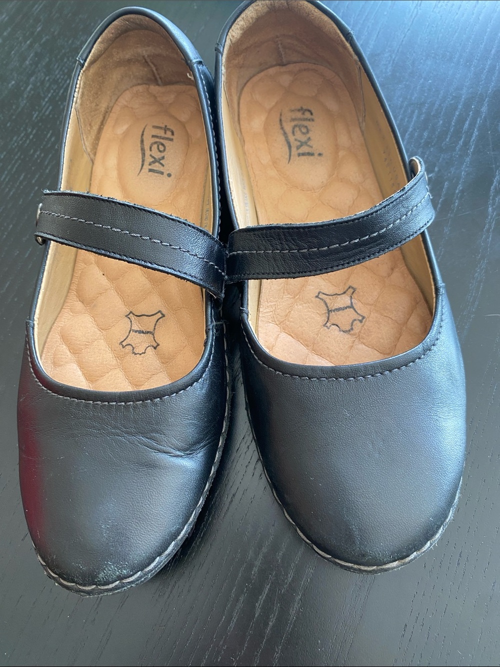 Flexi round toed Mary Jane black leather shoes. Strap has snap closure. Size 6.5